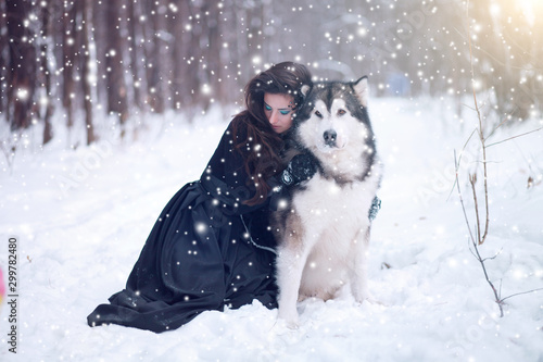Canvastavla Fairy tale girl embracing cute dog in winter park.
