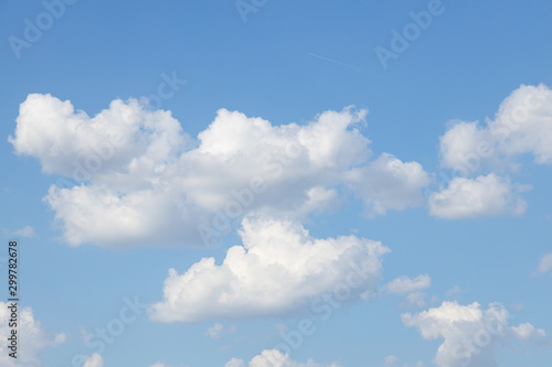 Clear blue sky with white cumulus clouds