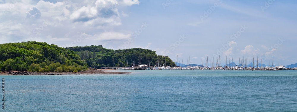 Island, Ocean views near Phuket Thailand with Blues, Turquoise and Greens oceans, mountains, boats, caves, trees resort island of phuket Thailand. Including Phi Phi, Ko Rang Yai, Ko Li Pe and other is