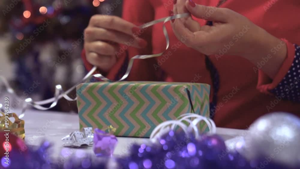 Slow motion Christmas handmade gift as a woman hands wrapping present. Slow motion Christmas handmade gift as a woman hands wrapping present.
