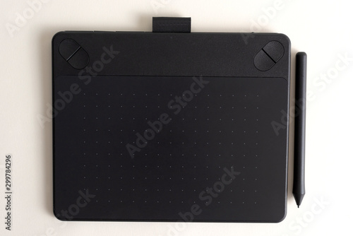 Black graphic tablet with pen for illustrators and designers. Graphic digital touch tablet with white background ,stylus pen 