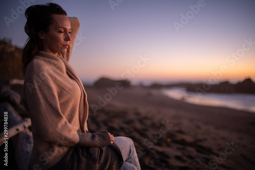 Woman enjoying sunset near ocean