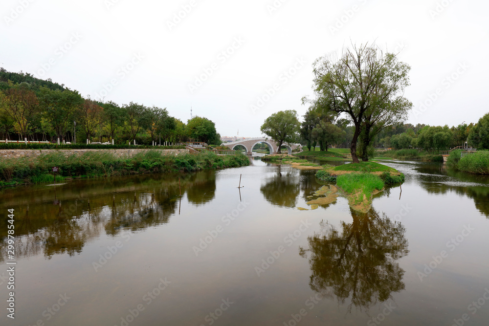 stone arch bridge built in a park