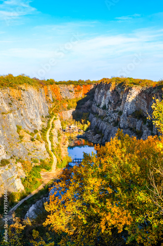 Limestone quarry Velka Amerika in Bohemia, Czechia. Partly flooded quarry surrounded by rocks and trees. Popular tourist attraction and film location. Nature in the Czech Republic