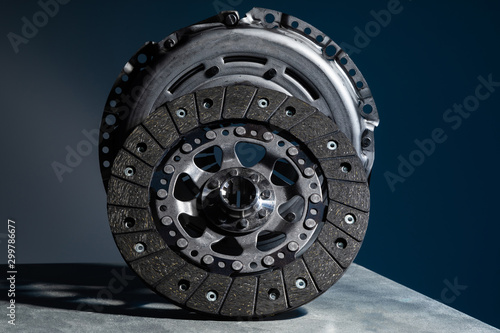 Close-up picture of a part of car, black clutch disk isolated on black background