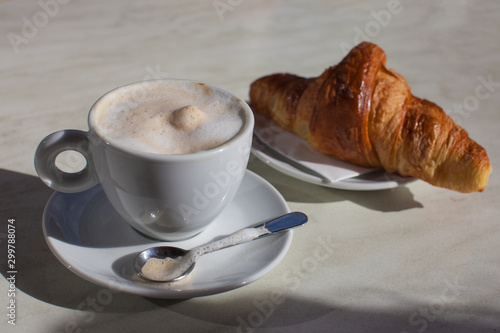 Fototapeta Naklejka Na Ścianę i Meble -  Cup of coffee cafe latte with croissant from outdoor cafe in Paris