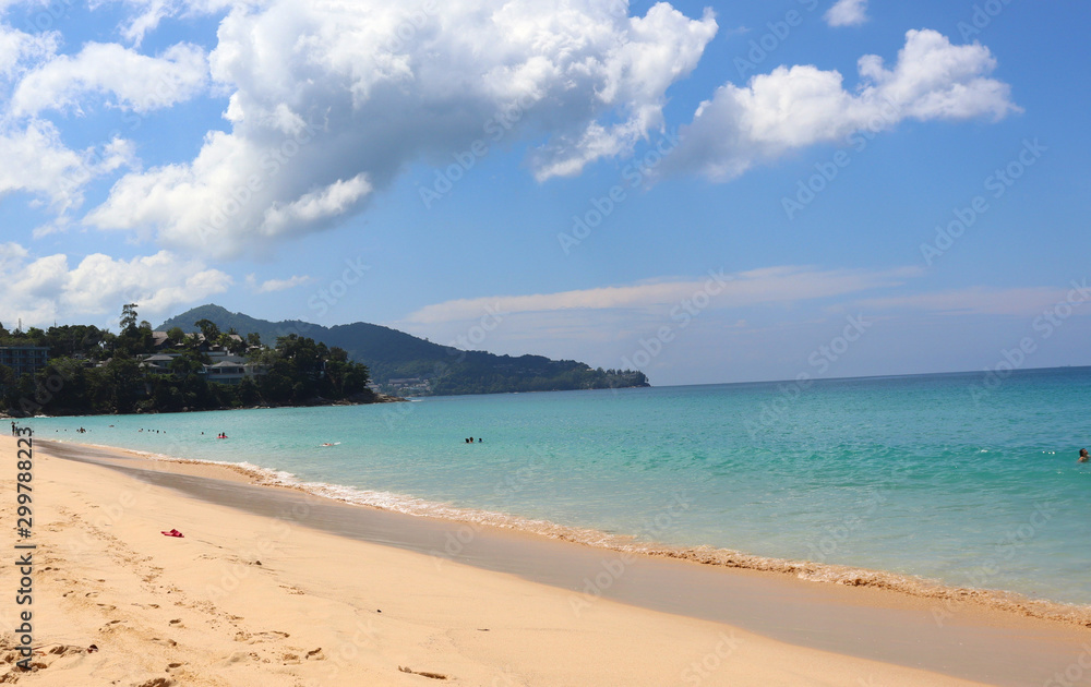 view of patong beach in phuket, sea waves roll on the sandy shore, foam and spray of water