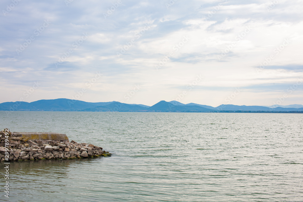 Sea, lake and blue sky majestic mountains skyline in the distance Sea, lake and blue sky majestic mountains skyline in the distance