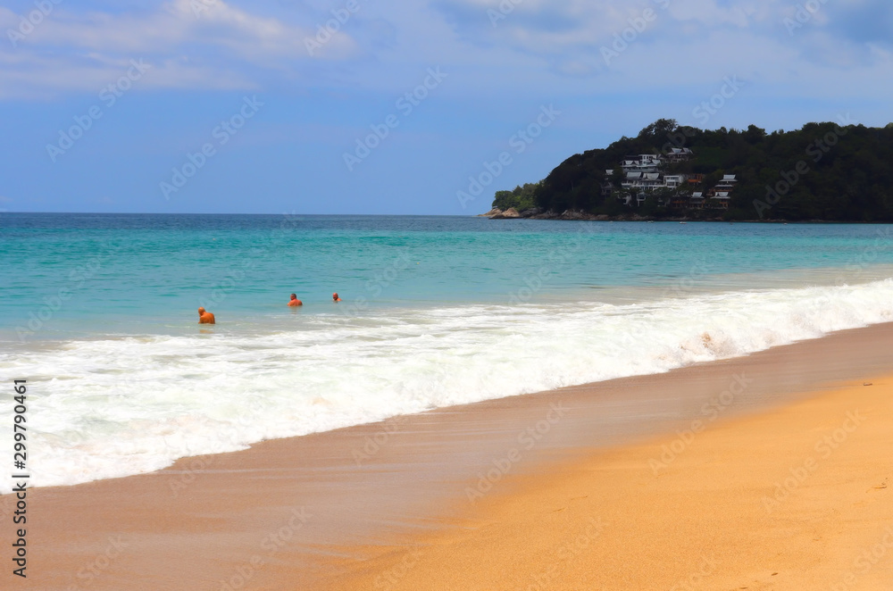 view of patong beach in phuket, sea waves roll on the sandy shore, foam and spray of water