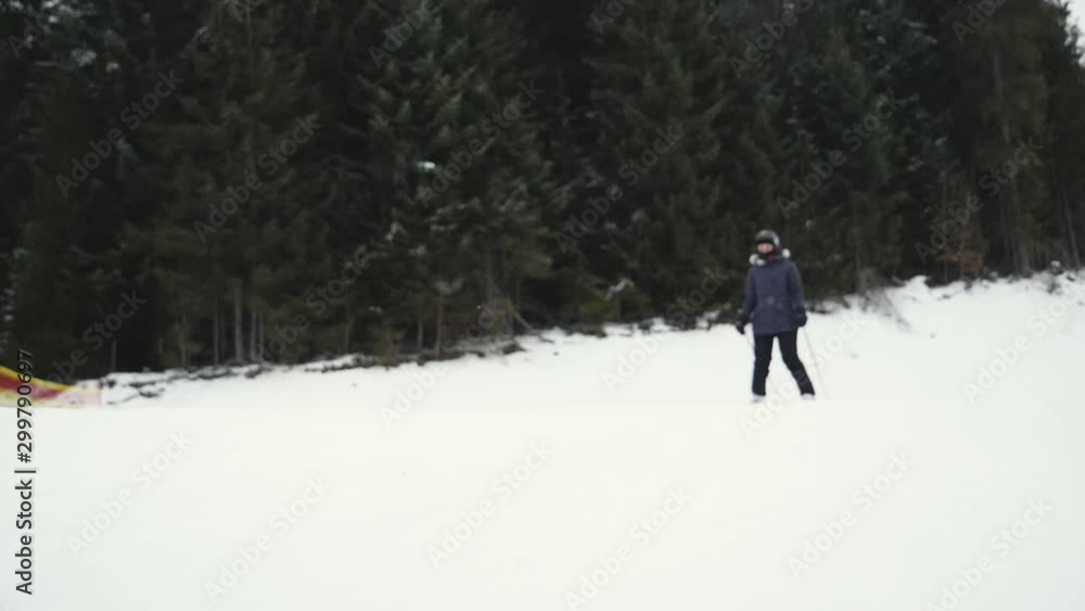 Woman skiing on snowy hill in mountains, slow motion effect. Winter vacation Woman skiing on snowy hill in mountains, slow motion effect. Winter vacation