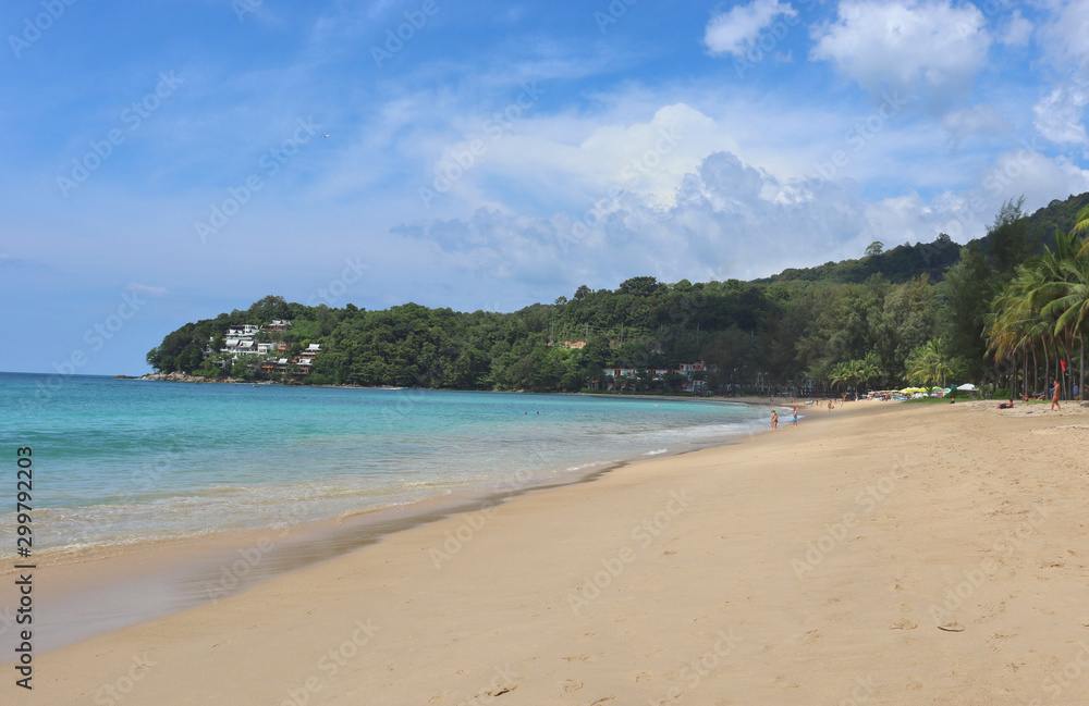 view of patong beach in phuket, sea waves roll on the sandy shore, foam and spray of water