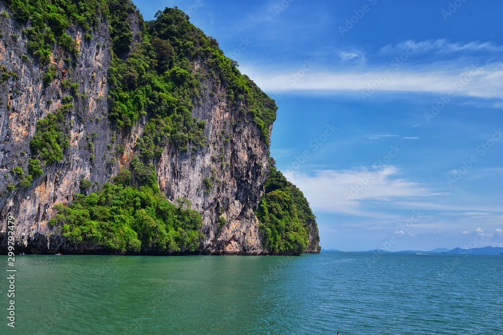 Island, Ocean views near Phuket Thailand with Blues, Turquoise and Greens oceans, mountains, boats, caves, trees resort island of phuket Thailand. Including Phi Phi, Ko Rang Yai, Ko Li Pe and other is