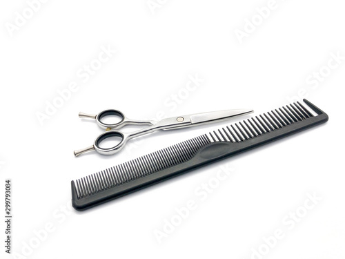 Professional scissors and comb isolated on white background. Real hairdressing tools. Set of scissors and combs for cutting hair