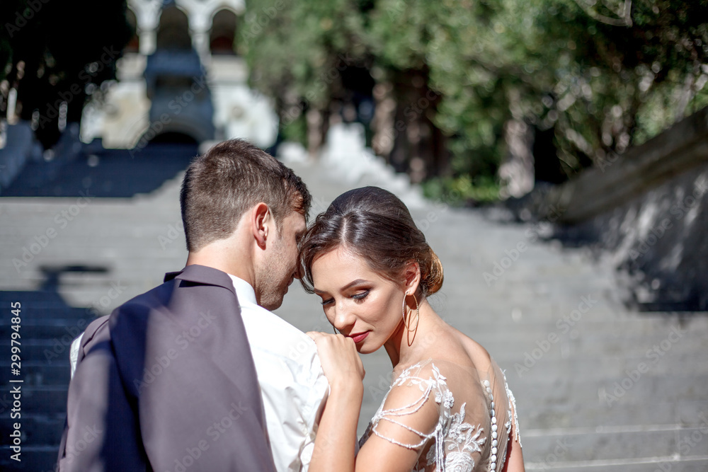 Portreit of bride and groom standing face to face on the romantic old city. Bride wearing elegant wedding dress