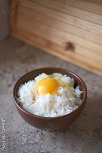 Obraz na plátně Tamago kake gohan with raw egg in bowl, vertical orientation