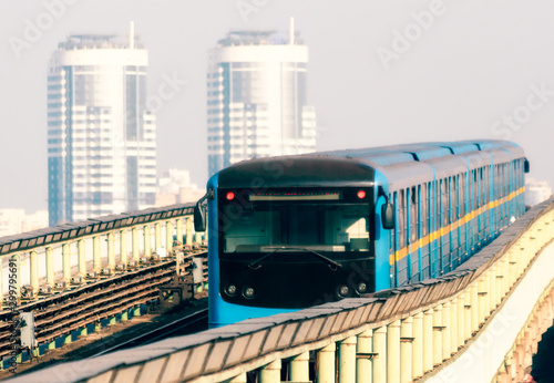 modern subway cars on the background of office skyscrapers in the morning