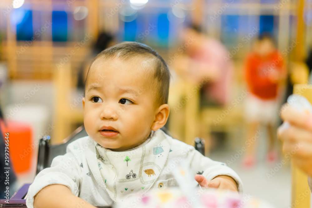 Portrait of adorable baby boy with funny hungry face sitting on table in restaurant while waiting for food. Portrait of adorable baby boy with funny hungry face sitting on table in restaurant while waiting for food.