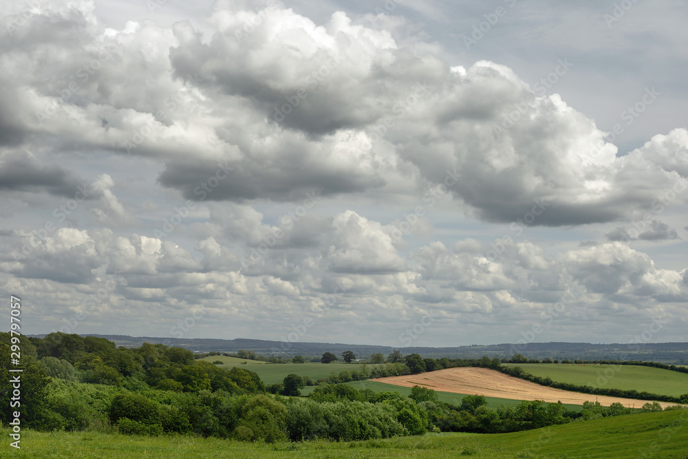 Cloudy sky over the Vale of Aylesbury, Buckinghamshire, United Kingdom showing open green fields for miles