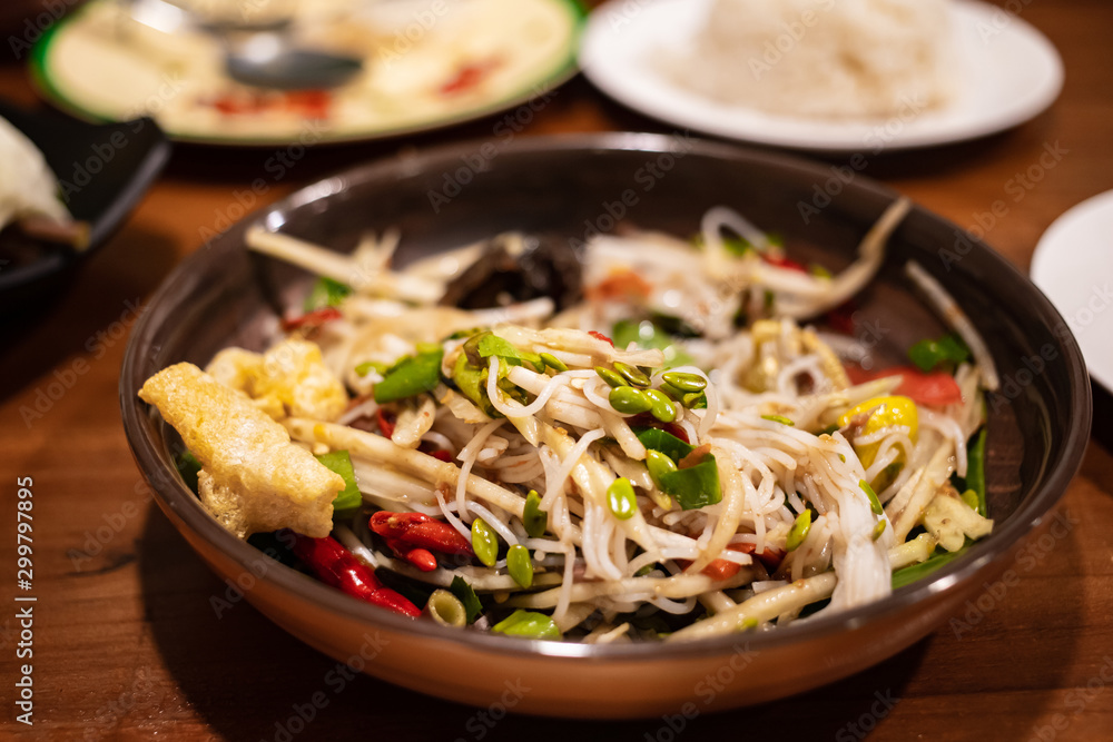 Plate of hot and spicy papaya salad in Thai street food restaurant Plate of hot and spicy papaya salad in Thai street food restaurant