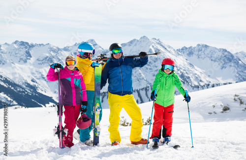 Happy family enjoying winter vacations in mountains . Ski, Sun,Snow and fun.
