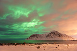 The Northern Lights (Aurora borealis) with mountain range in winter, Reine, Lofoten Islands, Nordland, Arctic