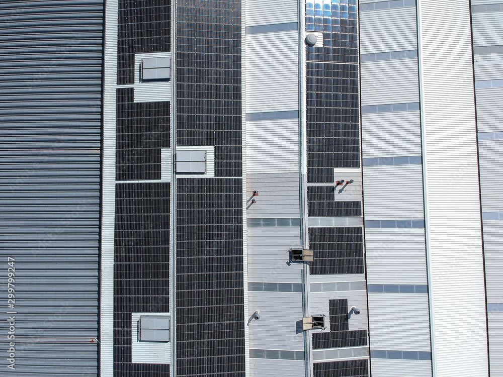 Solar panels on the roof of a factory for producing of green ecological electricity. Drone view