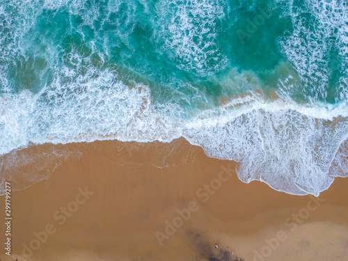 Sand beach aerial  top view of a beautiful sandy beach aerial shot with the blue waves rolling into the shore
