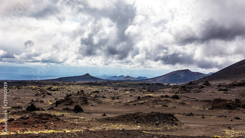 Deserted lifeless volcanic landscape near Volcano Tolbachik in the overcast weather. Kamchatka Peninsula, Russia