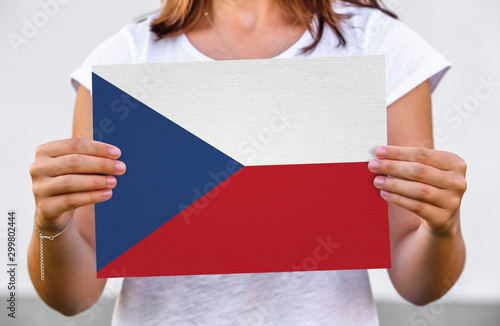 woman holds flag of Czech on paper sheet