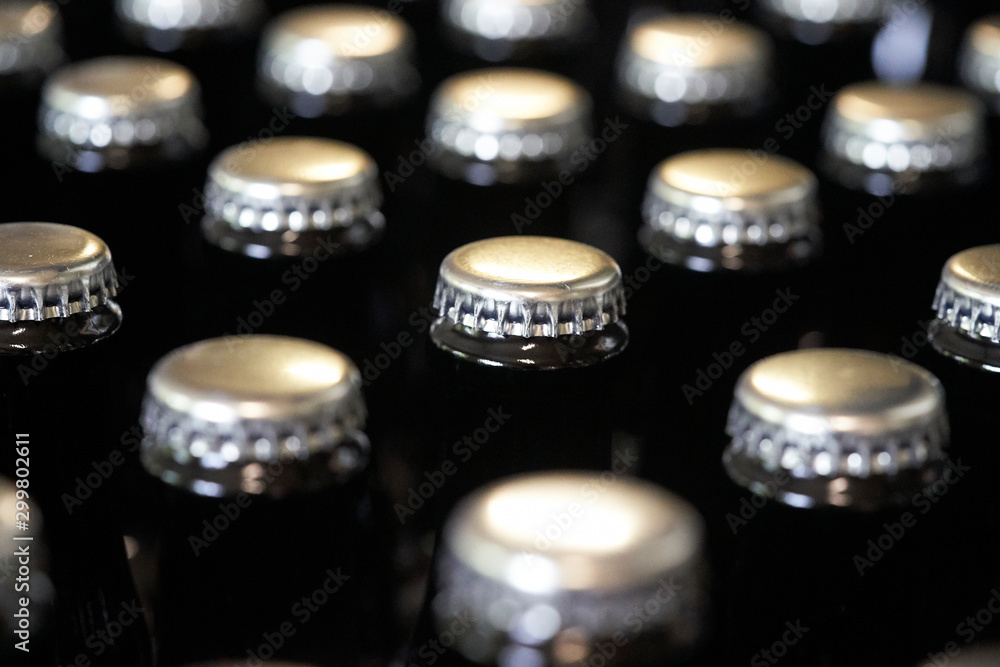 close up of crown caps on beer bottles close up of crown caps on beer bottles