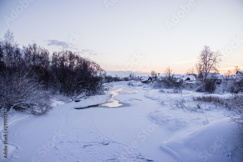 A small river in winter . Winter landscape. Water in rivers. Winter trees. Snow.