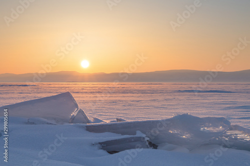 Colorful sunset over the crystal ice of Baikal lake