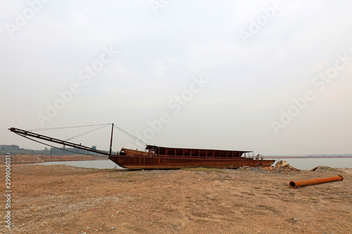 Simple sand dredger by river bank