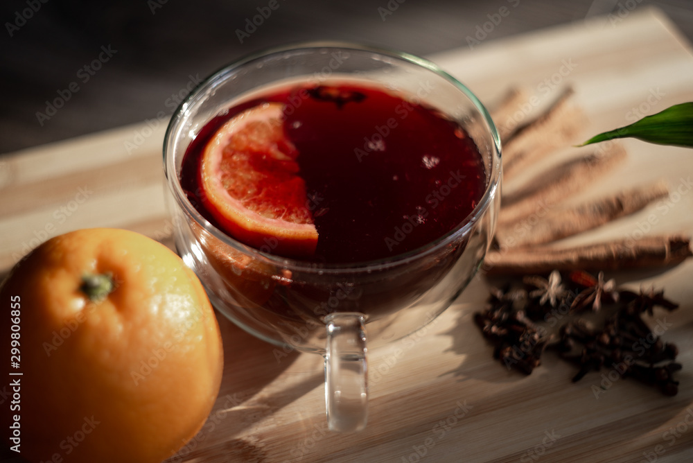 mulled wine on a wooden tray with orange and spices. Mulled wine ingredients. Winter cocktail. drink in a double bottom cup. mulled wine on a wooden tray with orange and spices. Mulled wine ingredients. Winter cocktail. drink in a double bottom cup.