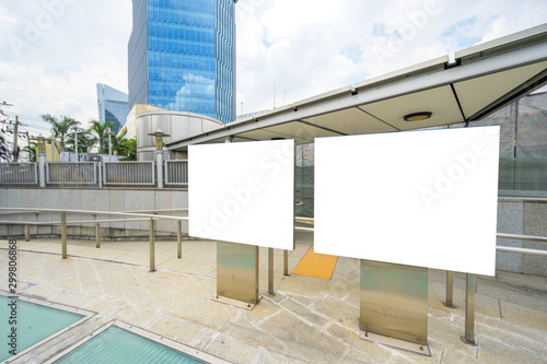 A blank advertisement board is located in front of the subway entrance. © Patcharanan