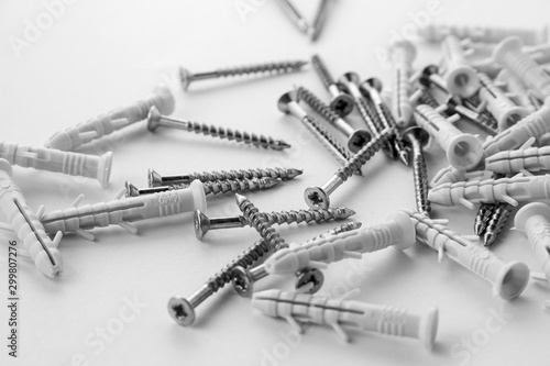 A small number of screw anchors that are scattered on a white background. Plastic plugs with screws for repair.