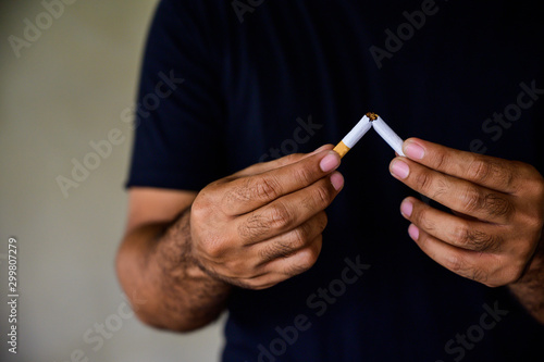 Male hand crushing cigarette. Stop smoking concept