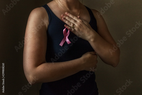 October is breast cancer awareness month,a woman holds a pink ribbon to support people living and sick.Health, international women's day and the concept of the world day of fight against cancer.Noises