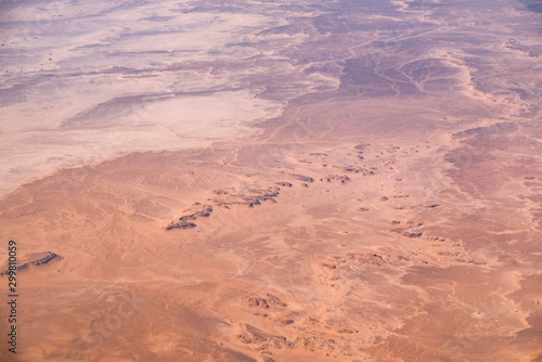 Aerial airplane view of barren Sahara desert landscape in Egypt