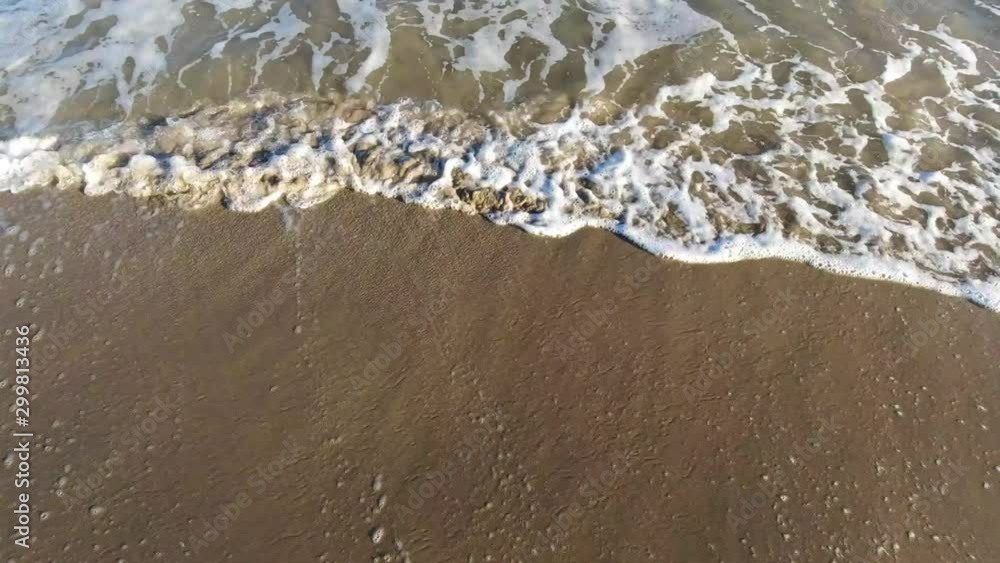 Beautiful sandy beach video with wave reaching shore Beautiful sandy beach video with wave reaching shore