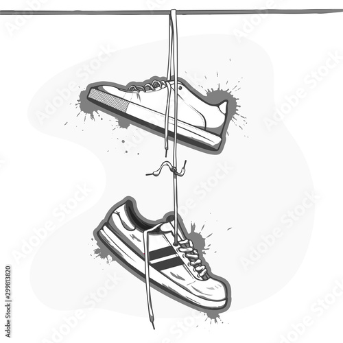 Sneakers hanging from a rope on the white background