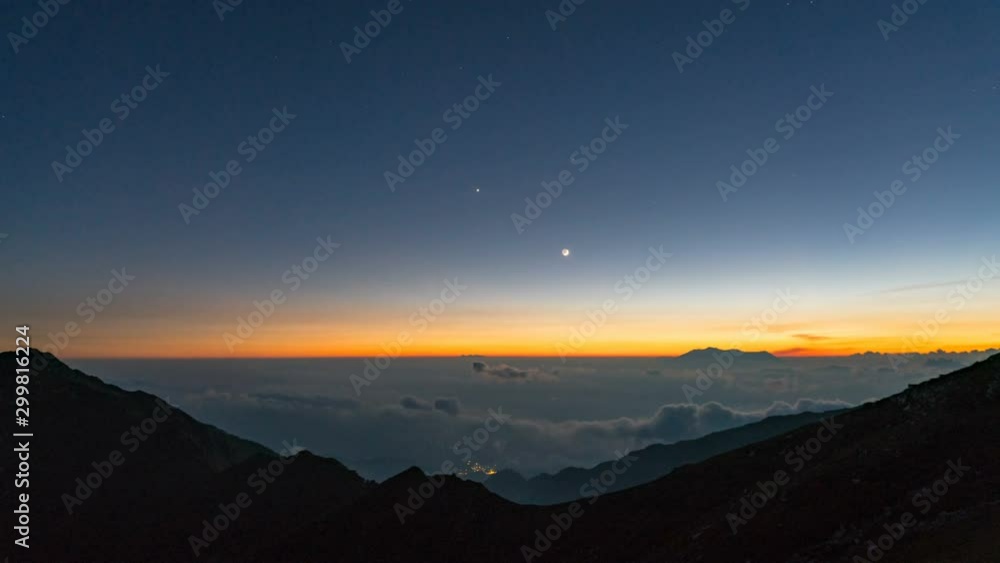 Timelapse of Crescent Moon Setting in Twilight Sky over Sea of Clouds Timelapse of Crescent Moon Setting in Twilight Sky over Sea of Clouds