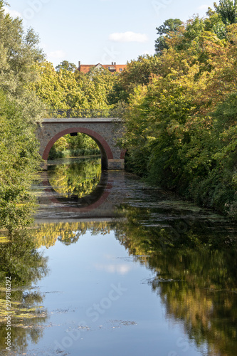 View of historic bridges at Karl Heine Canal in Leipzig / Germany with a newly created bicycle and hiking path