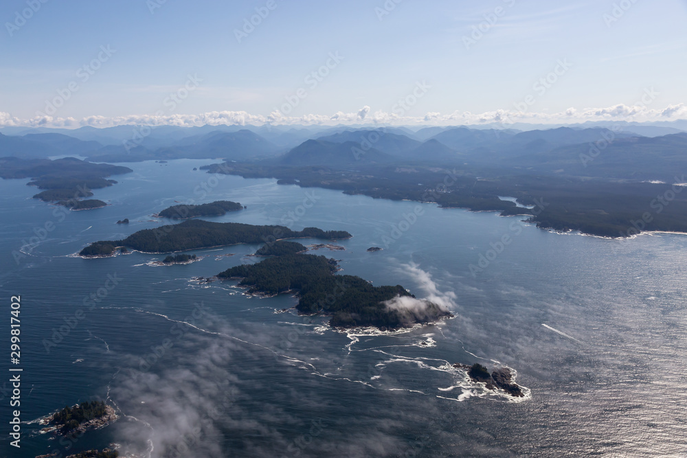 Aerial Landscape View of Beautiful Pacific Ocean Coast with Coastal Mountains at the background during a sunny summer morning. Taken near Tofino and Ucluelet, Vancouver Island, BC, Canada.