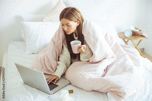 Concentrated girl reading income message on gadget