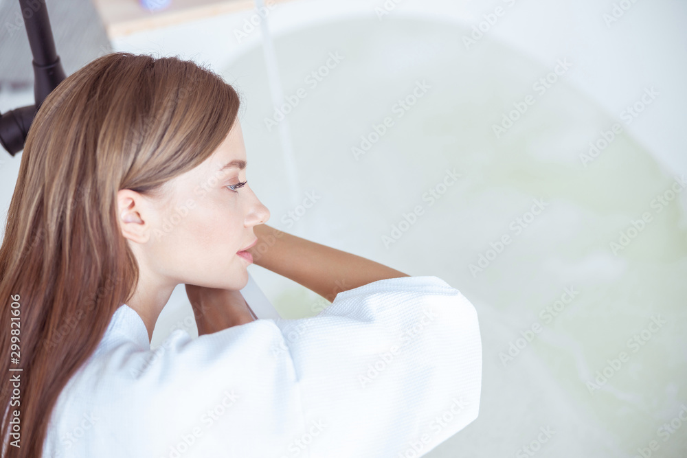 Thoughtful young female is staring at water Thoughtful young female is staring at water