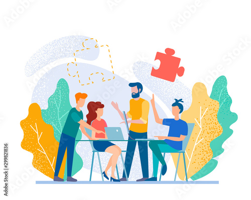 Men and women sitting at desk and standing, working at computers and talking with colleagues