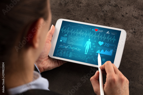 Business woman making healthy analysis on tablet photo