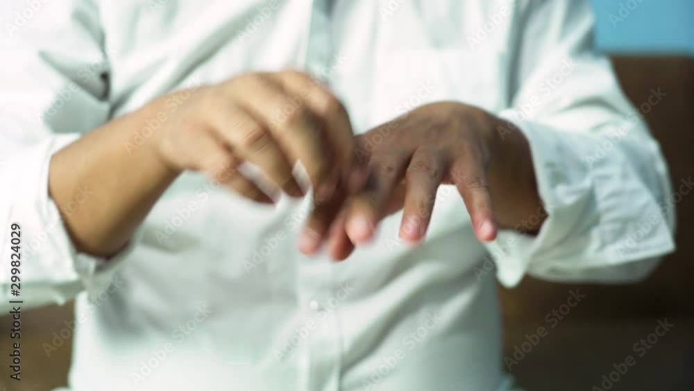A man scratching his hand Because of itching A man scratching his hand Because of itching