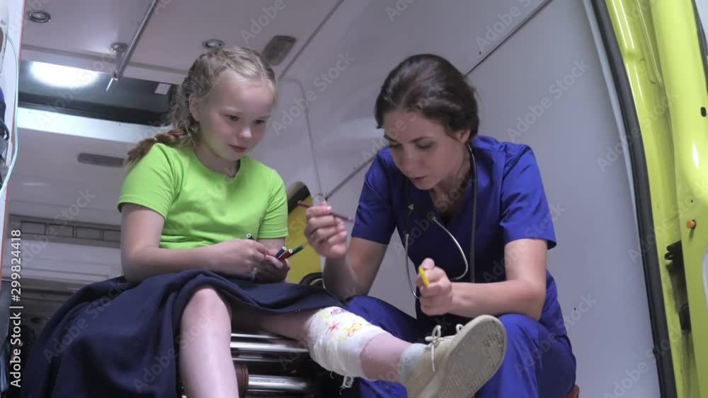 Sick girl sit with nurse in ambulance car. Sick girl sit with nurse in ambulance car.